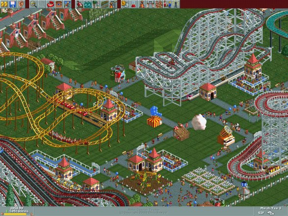 A RollerCoaster Tycoon park from above: wooden and steel coasters winding between stalls, paths and crowds of guests.